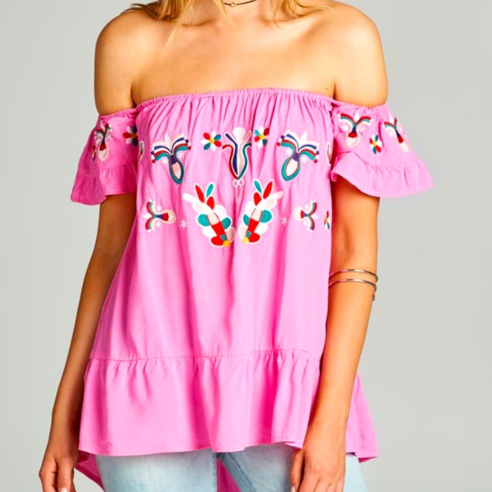 Pink billowy off the shoulder top w floral appliqué.